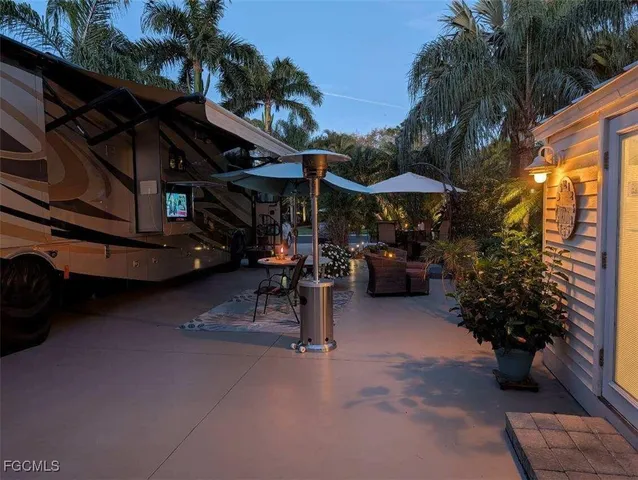 a view of a patio with table and chairs under an umbrella