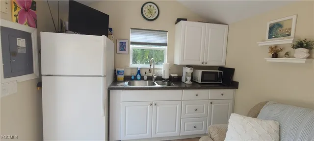 a kitchen with appliances a counter space and a window