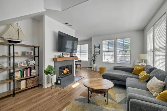 a living room with furniture a fireplace and a flat screen tv