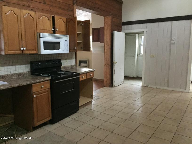 110 Center Avenue Mount Pocono, PA 18344 - Photo 2 of 14 a kitchen with granite countertop a stove a sink and a microwave