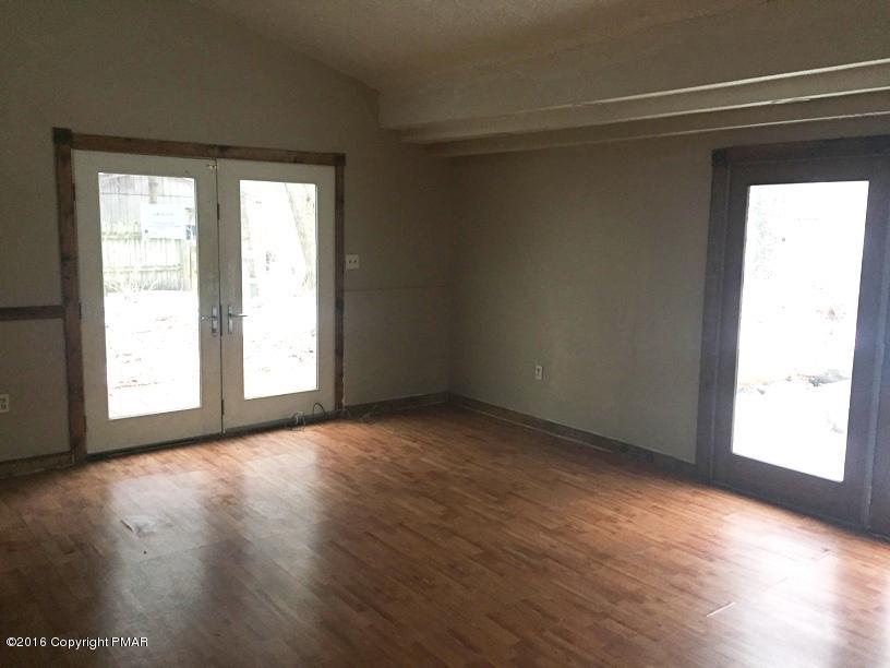 110 Center Avenue Mount Pocono, PA 18344 - Photo 4 of 14 an empty room with wooden floor and windows