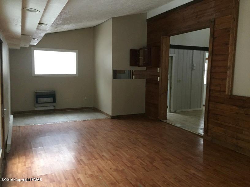 110 Center Avenue Mount Pocono, PA 18344 - Photo 5 of 14 an empty room with wooden floor and a window