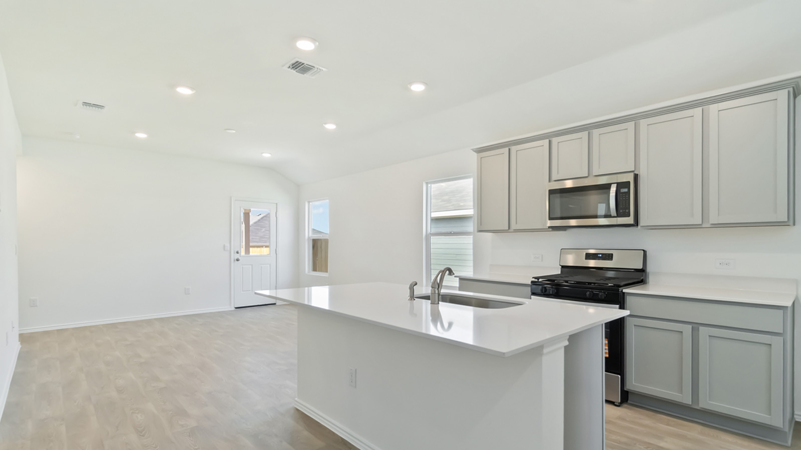 265 Balmorhea Street Kyle, TX 78640 - Photo 12 of 25 a kitchen that has a sink and a stove top oven