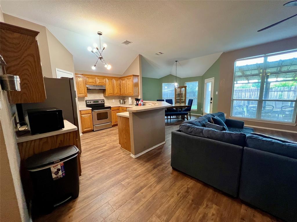 12201 Rolling Ridge Drive Fort Worth, TX 76028 - Photo 7 of 21 Open-concept living space with vaulted ceilings