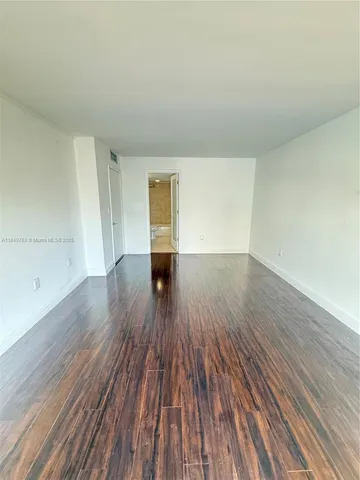 a view of walk in closet with wooden floor