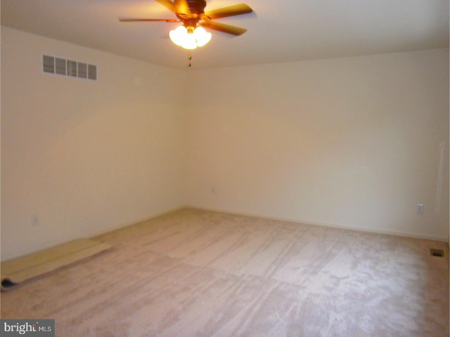 91 Cheney Road Mannington, NJ 08098 - Photo 8 of 13 an empty room with a window and a fan