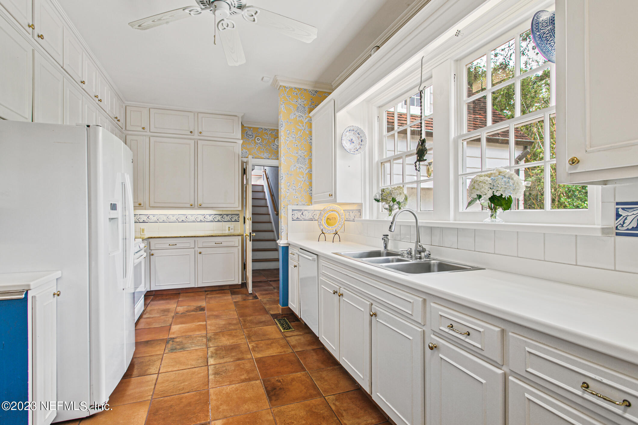 2103 River Road Jacksonville, FL 32207 - Photo 15 of 67 a kitchen with white cabinets and white appliances