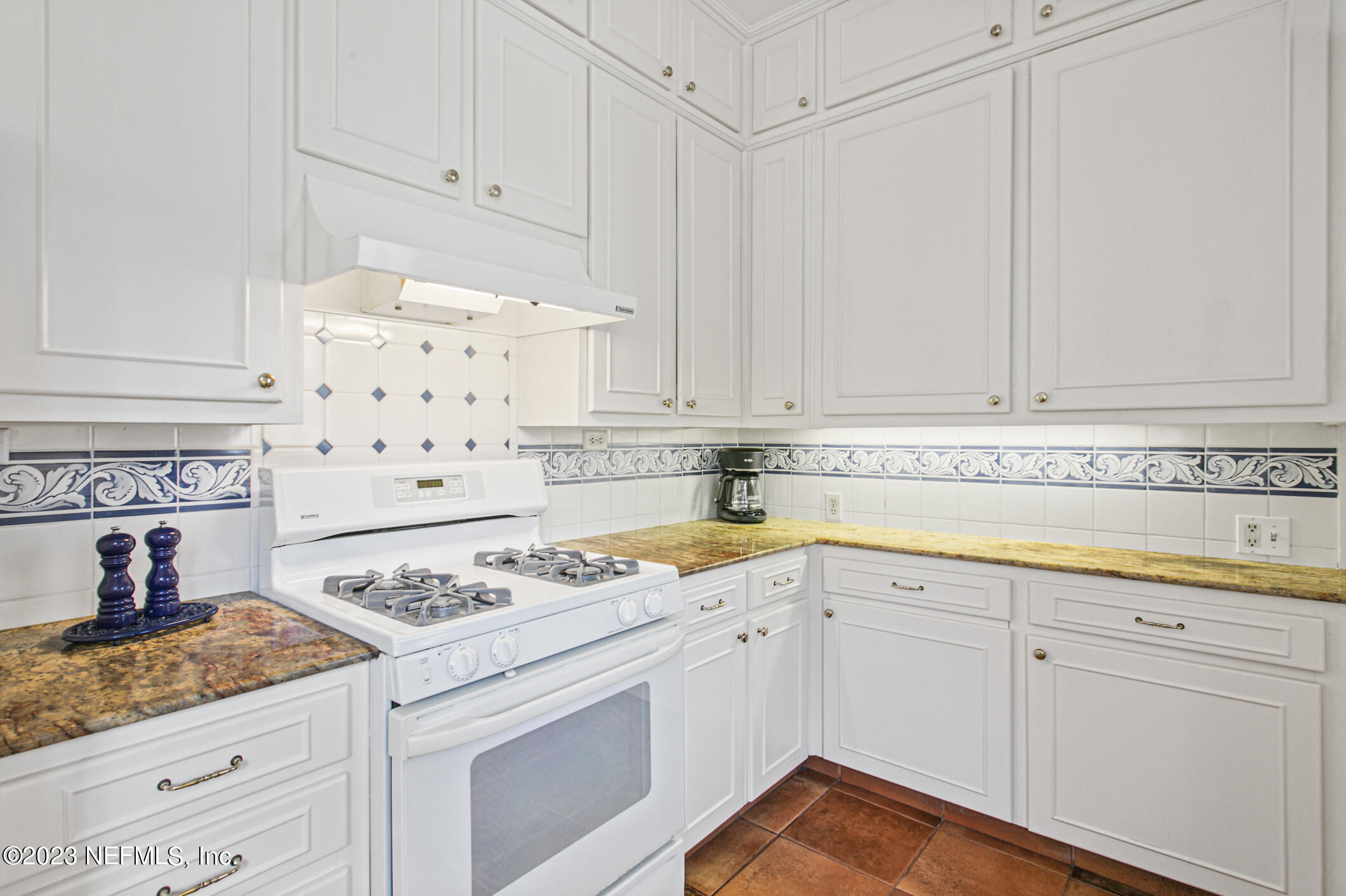 2103 River Road Jacksonville, FL 32207 - Photo 17 of 67 a kitchen with granite countertop white cabinets and sink