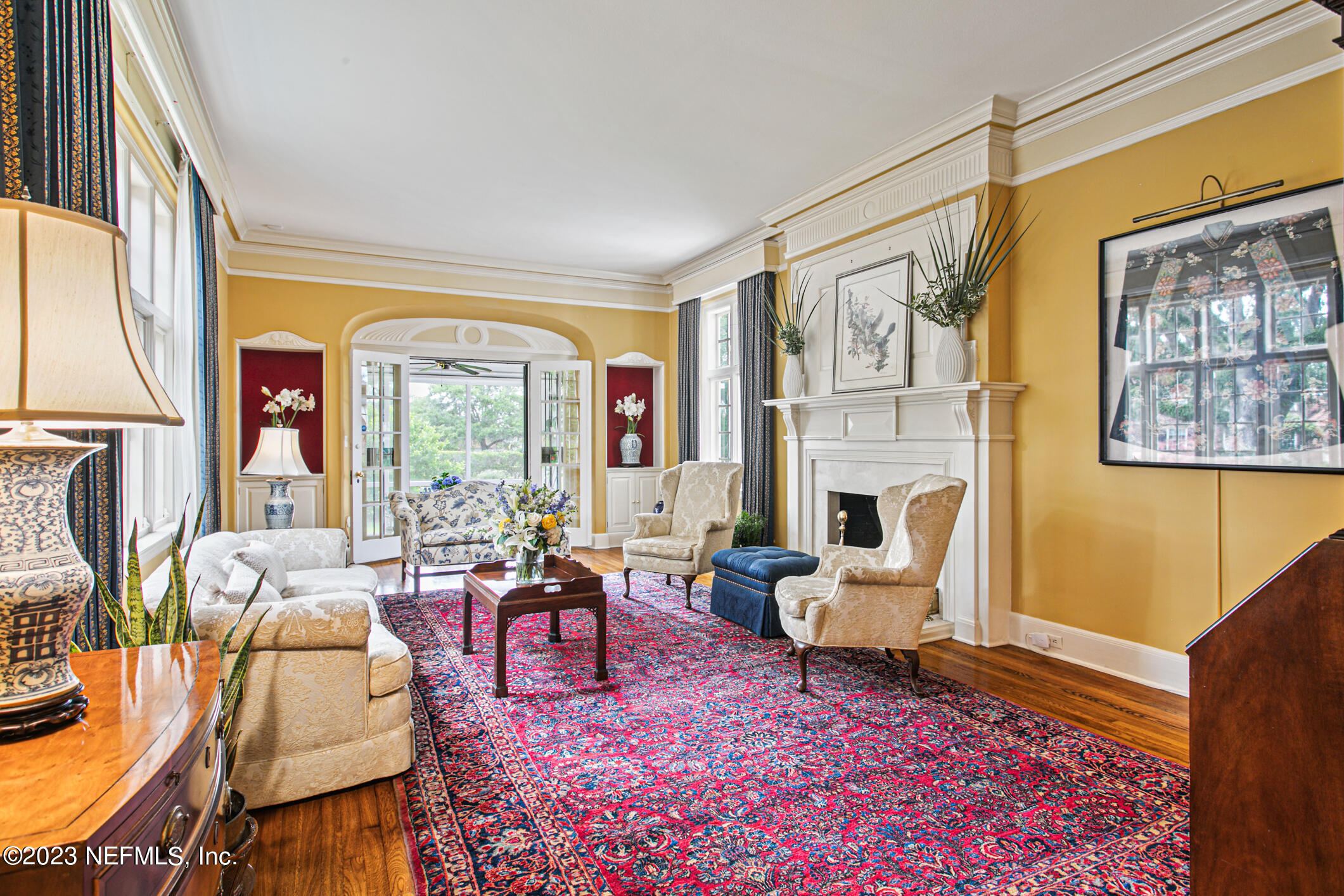 2103 River Road Jacksonville, FL 32207 - Photo 9 of 67 a living room with furniture a fireplace and a floor to ceiling window