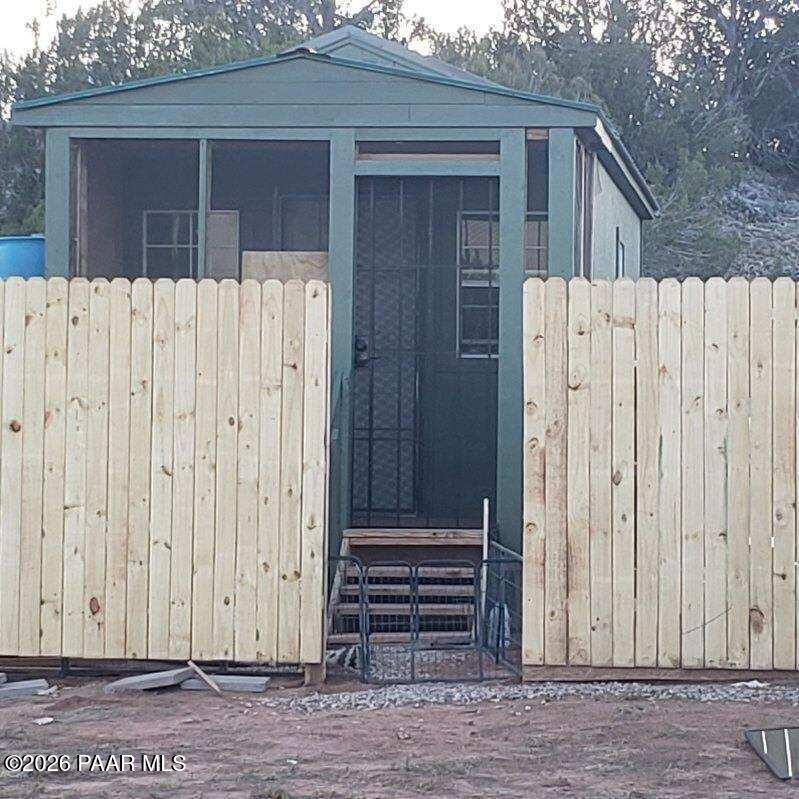 a view of a house with a wooden fence