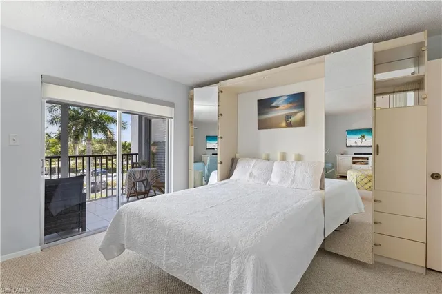 a bedroom with a large bed and a large window