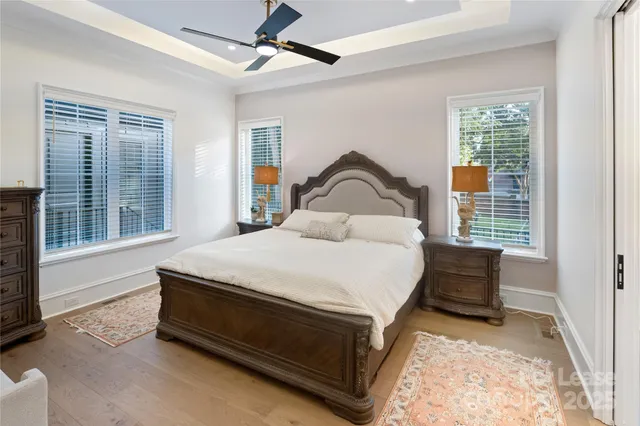 a bedroom with a bed and a large window