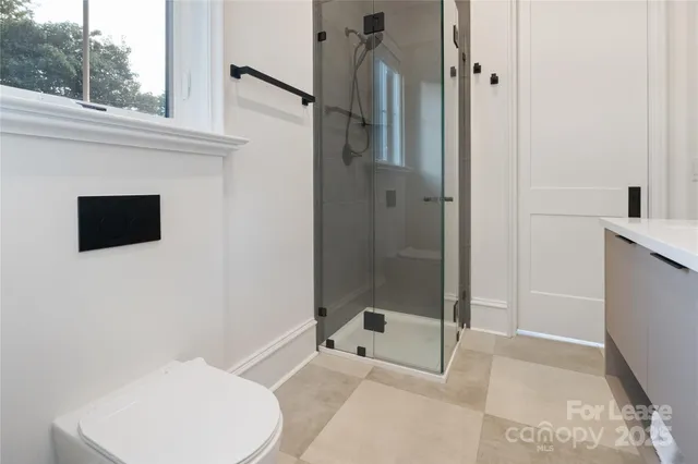 a bathroom with a toilet and a shower