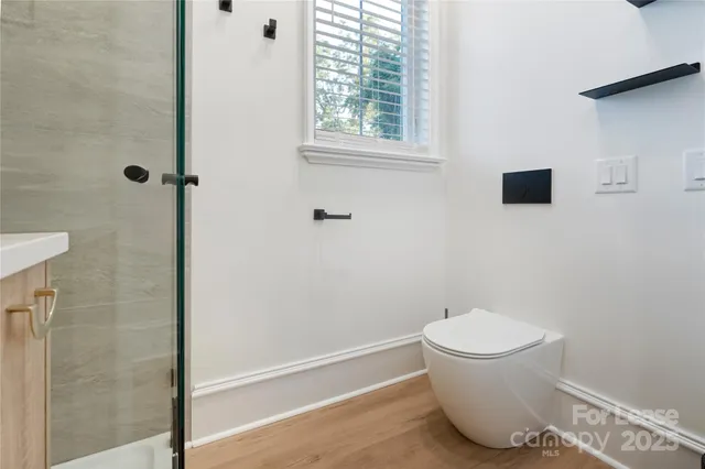 a bathroom with a toilet and a shower