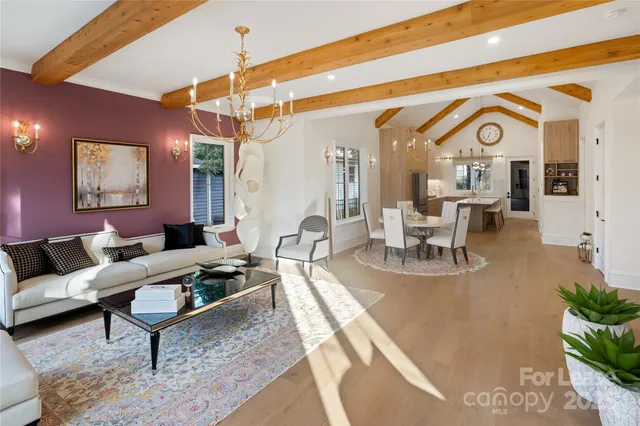 a living room with furniture a rug and white walls