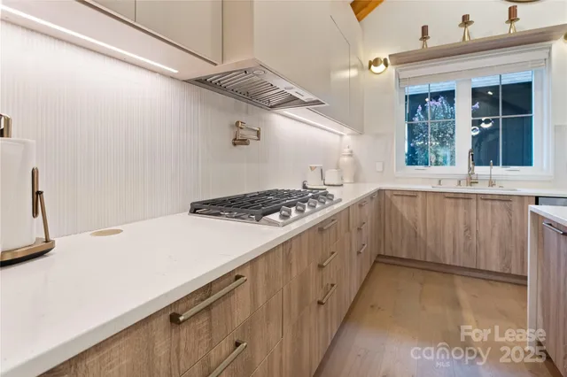 a kitchen that has a sink and a stove