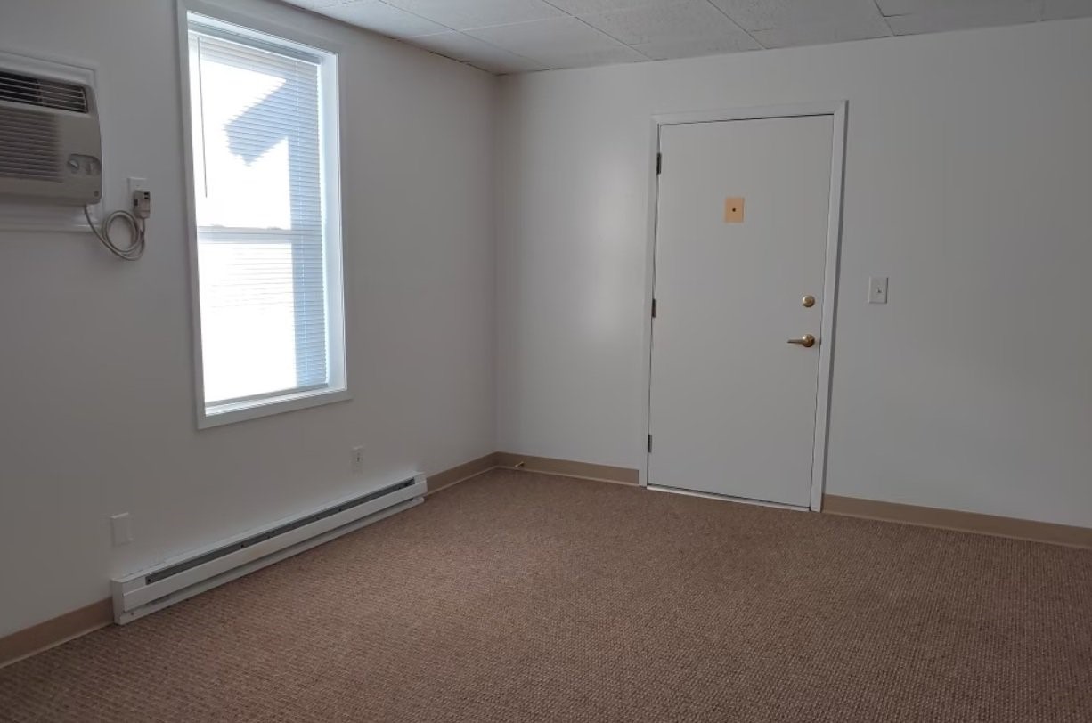 2202 Broadway Street Granger, IA 50109 - Photo 4 of 11 an empty room with windows