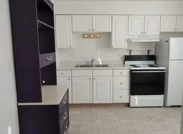 a kitchen with cabinets and appliances