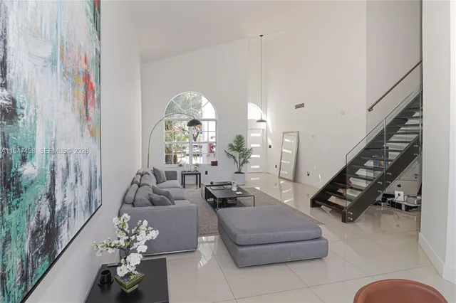 a living room with furniture flowers and a chandelier