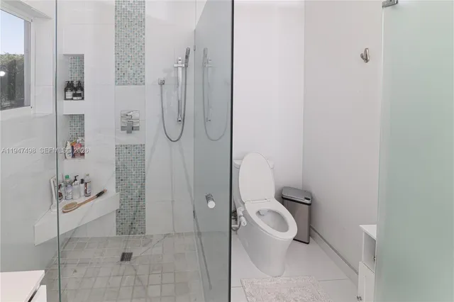 a bathroom with a toilet and shower