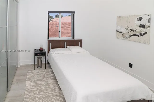 a bed room with a bed and a night stand