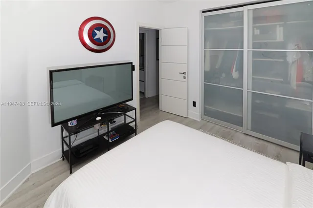 a living room with a flat screen tv and a large window