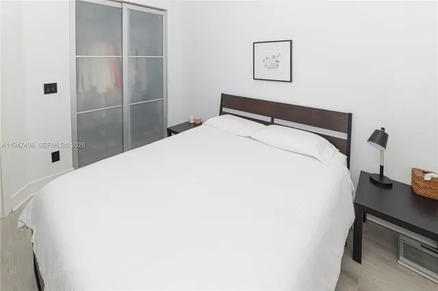 a bedroom with a bed and a table