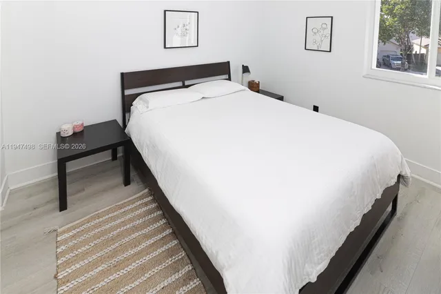 a bedroom with bed and window