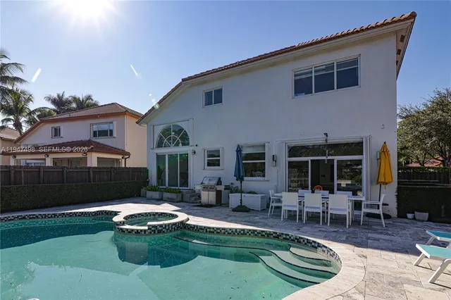 a house view with a sitting space fire pit and outdoor space