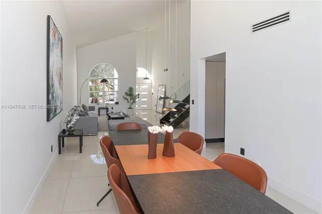 a view of a dining room with furniture and a chandelier