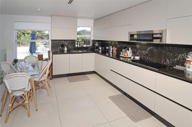 a kitchen with stainless steel appliances kitchen island granite countertop a sink and cabinets