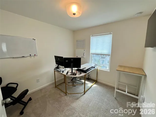 a work room with furniture and a window