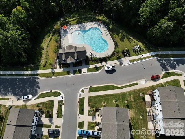 an aerial view of house with yard swimming pool and outdoor seating