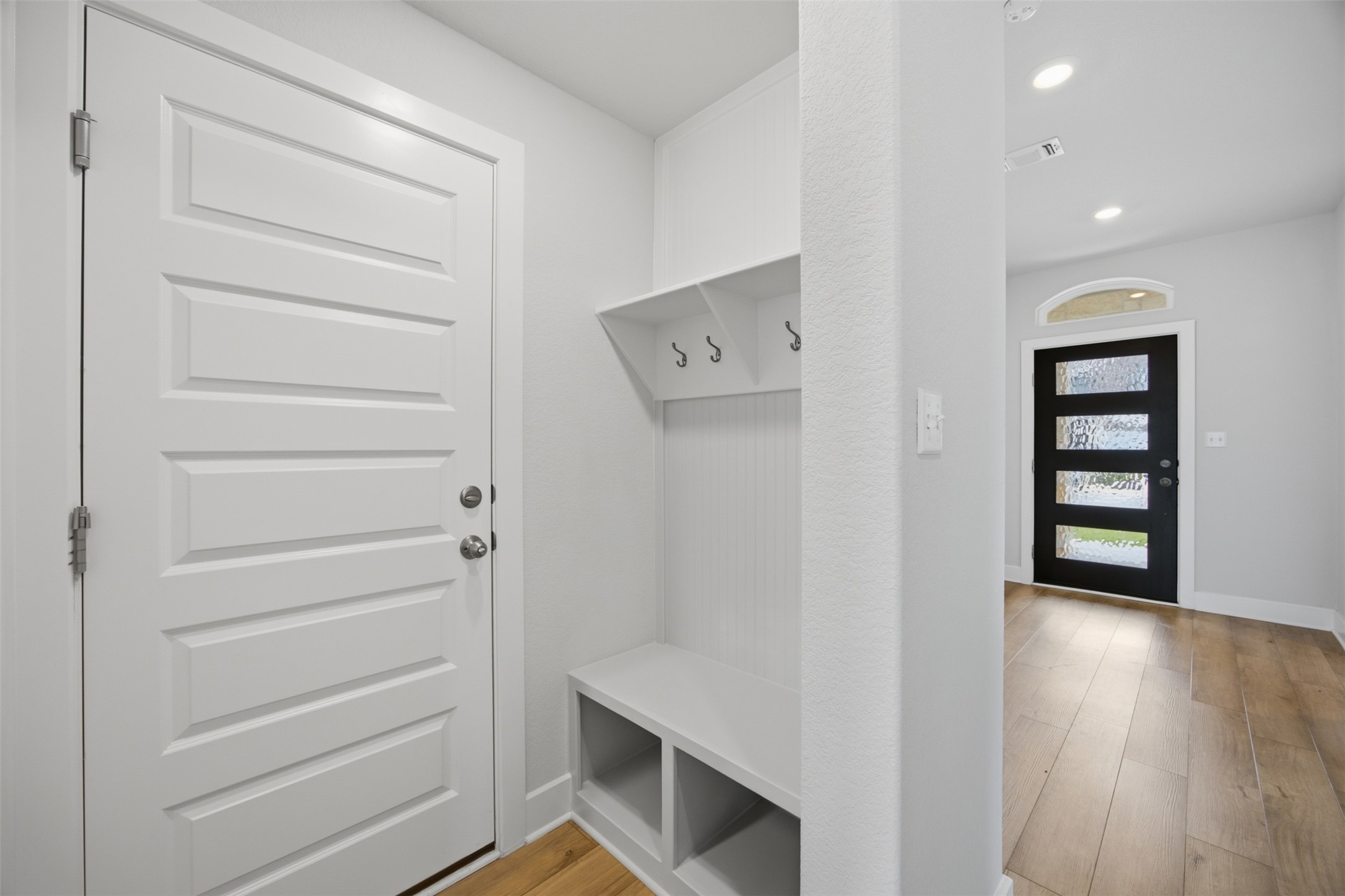 2101 Little Snake Way Georgetown, TX 78633 - Photo 7 of 37 Functional mudroom with built-in bench seating and convenient coat hooks, leading to an inviting entry.