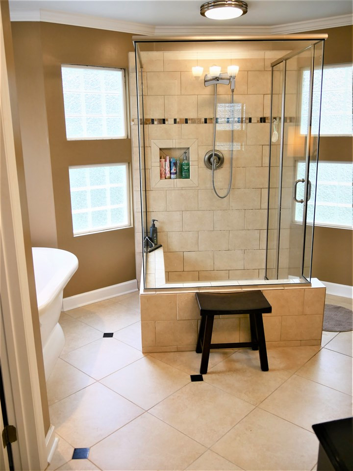 8512 Wheeling Drive Raleigh, NC 27615 - Photo 23 of 30 Master bath has soaking tub, custom shower and furniture style vanities. Master Bathroom