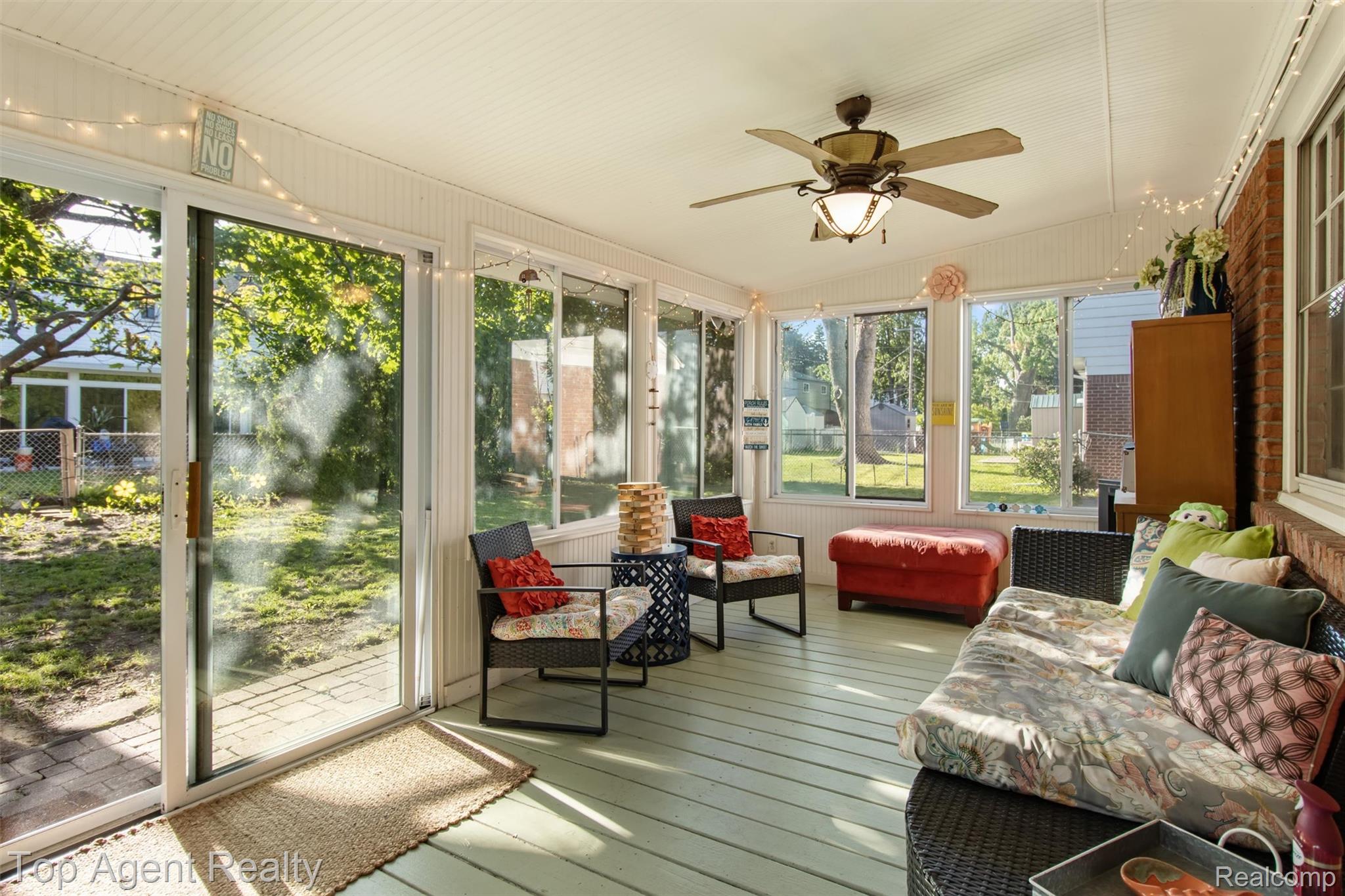 32341 Woody Road Fraser, MI 48026 - Photo 39 of 47 Sunroom featuring a ceiling fan with integrated lighting, multiple windows, and a sliding glass door providing direct outdoor access