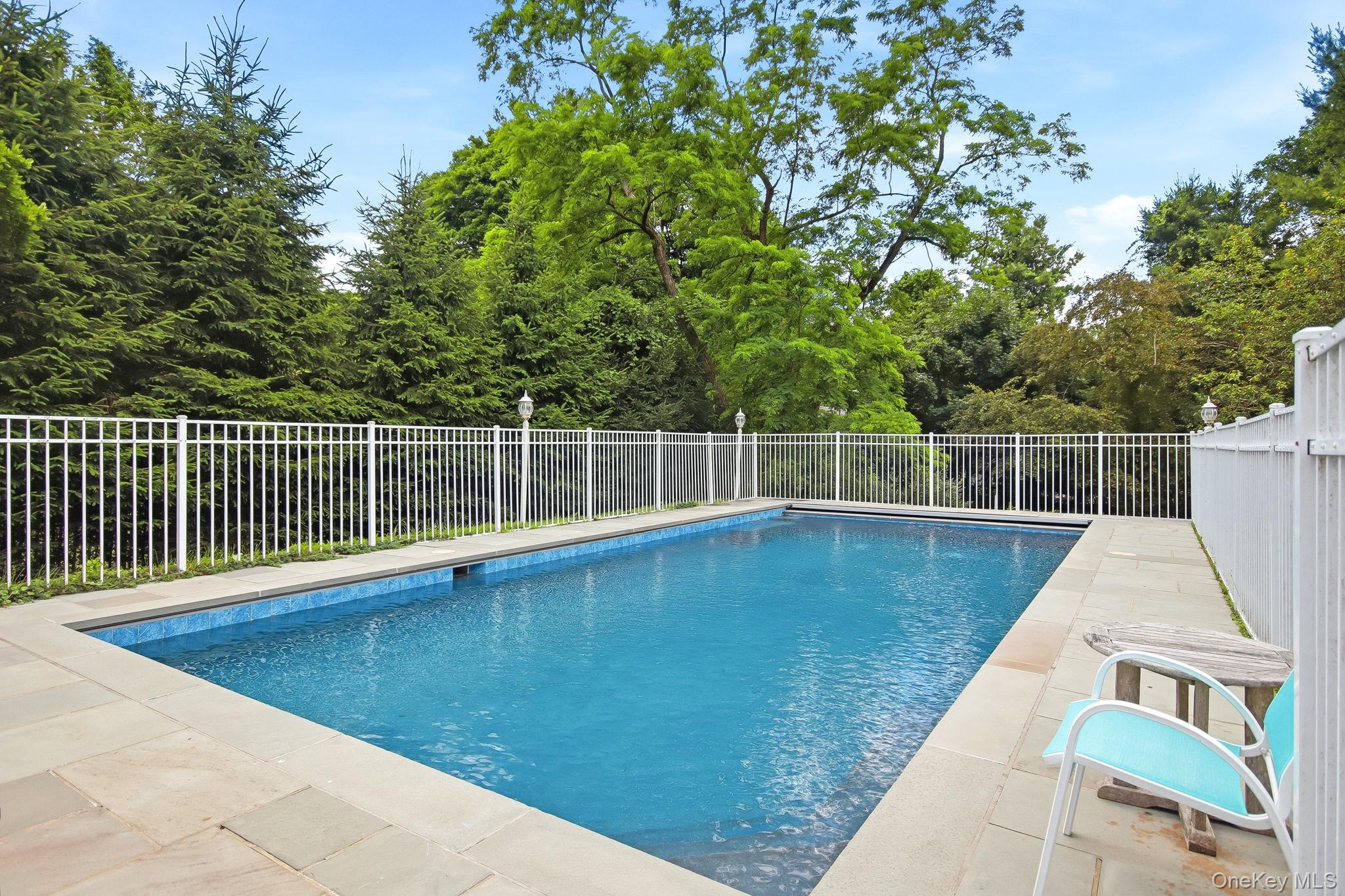 26 Century Ridge Road Purchase, NY 10577 - Photo 37 of 50 In-ground swimming pool featuring a tiled interior and stone coping
