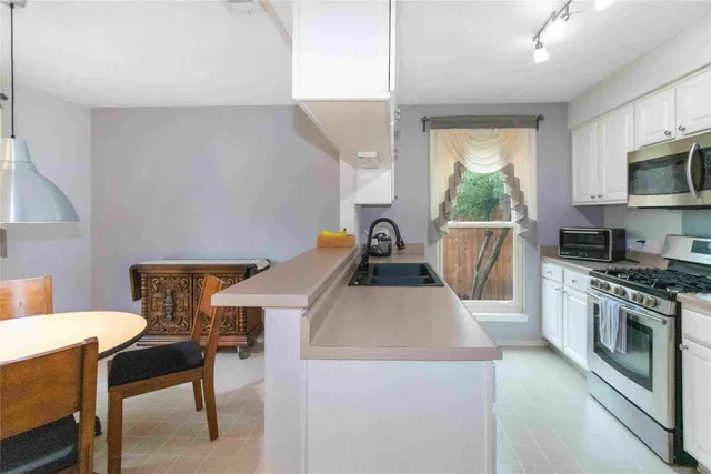 a kitchen that has a stove and a table