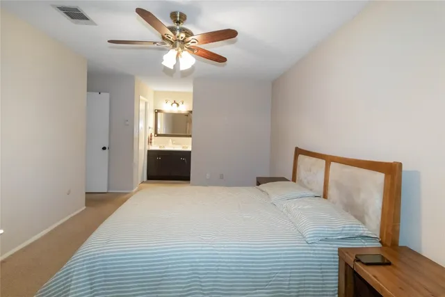 a bedroom with a large bed and a window