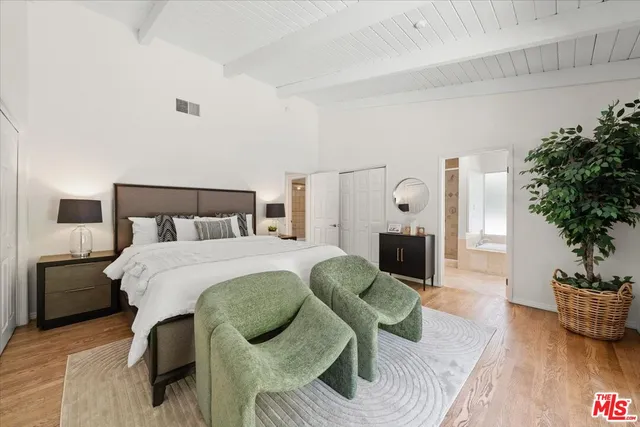 a bedroom with a bed and potted plant