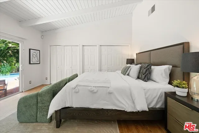 a bedroom with a bed window and a couch