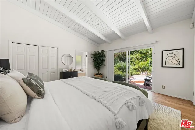 a bedroom with a large bed and a large window