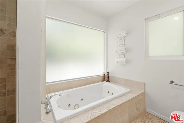 a bathroom with a tub and a shower