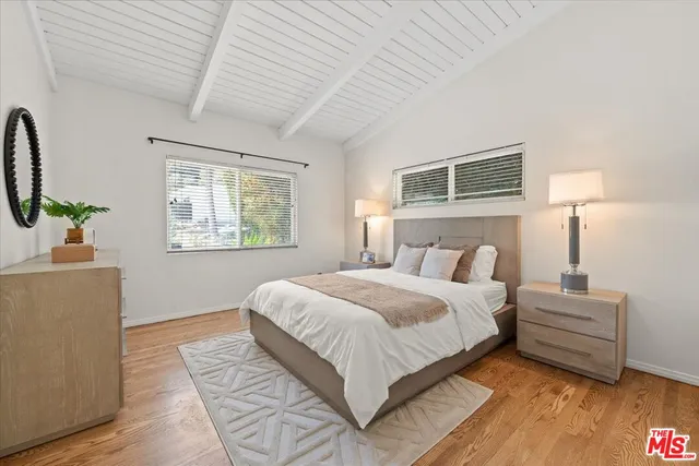 a bedroom with bed and window