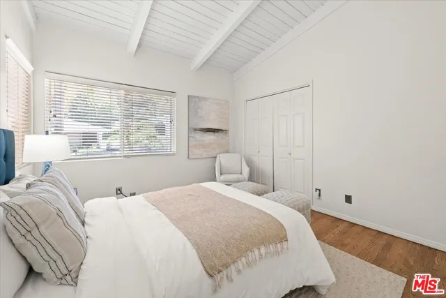 a bedroom with a bed and a large window