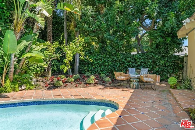 a view of a backyard with sitting area