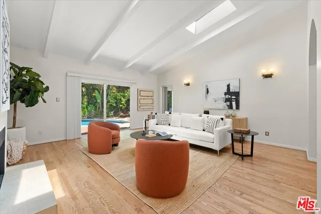 a living room with furniture a lamp and a potted plant
