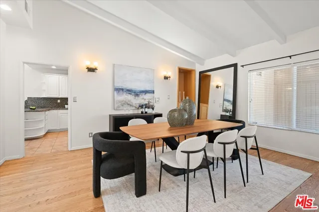 a dining room with furniture and wooden floor