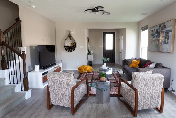 a living room with furniture and a flat screen tv