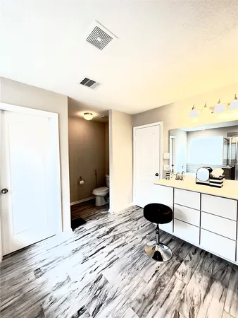a workspace with wooden floor and furniture